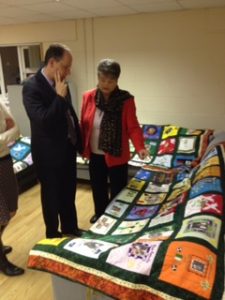 Chairperson of RFJ Clara Reilly shows Mr De Greiff some of the Remembering Quilt